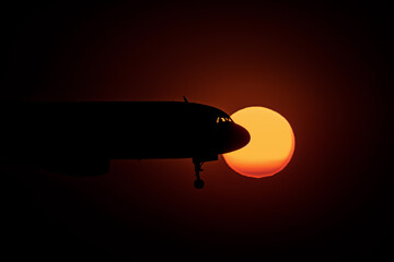 Fototapeta premium Plane gracefully soars through the sunset sky, AI-generated.