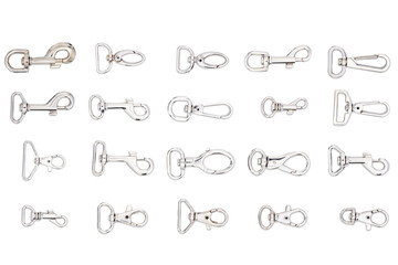 Clip hook isolated on white. Metal clothing element. Metal clip hooks for bags background. Various...