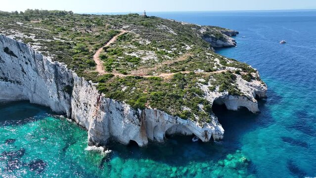 Blue Caves located between Aghios Nikolas and Cape Skinnari. Blue caves in zakynthos, Greece. Potamitis Dive Spot, Zakynthos, greece. Skinari View Point. Aerial drone view Turquoise ionian sea.