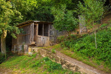 Fototapeta na wymiar A small wooden farm building and a chicken enclosure in Martin Brod in the Una National Park. Una-Sana Canton, Federation of Bosnia and Herzegovina. Early September