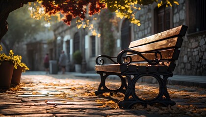bench in the park. Bench underneath a tree in an old European town. Bench on a pebble street surrounded by old architecture and foliage. Solitary bench with moody lightning