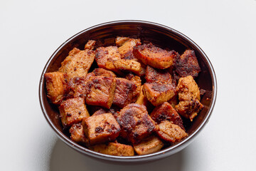 Pieces of fried pork meat, ready to eat in a bowl.
