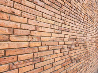 The texture of a red brick wall or an unevenly colored brick wall is perfect for adding text or as a background. A red brick wall shot in a horizontal direction.
