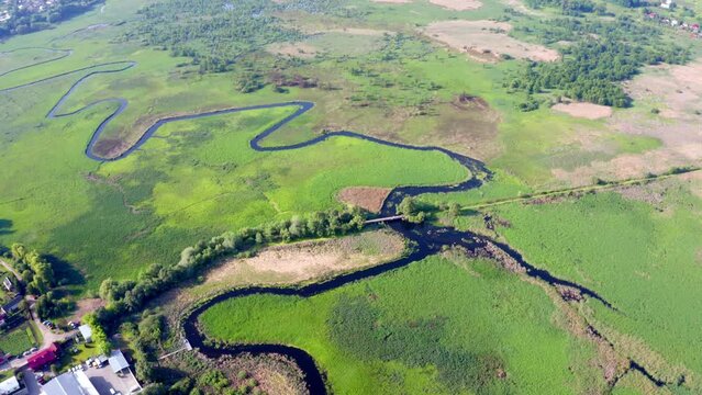 4k drone flight down footage (Ultra High Definition) of Seret river, Ternopil region, Ukraine, Europe. Spectacular summer scene of green flooded valley. Beauty of nature concept background.