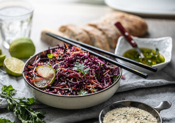 Asian red cabbage and carrot salad seasoned with coriander and sesame - obrazy, fototapety, plakaty