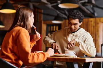 young and diverse couple enjoying tasty lunch at a rustic wooden table in charming restaurant