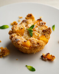 Peach crumble tartlet in a French pastry shop in Paris.