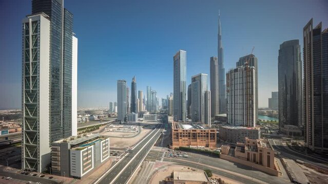 Aerial view of Dubai Downtown skyline during sunrise with long moving shadows from tall towers timelapse. Business area in smart urban city. Skyscrapers and high-rise buildings from above, UAE.