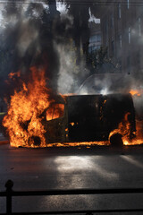 Protestors set a van on fire during protests in Athens Greece.