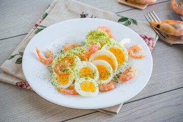 boiled eggs with boiled shrimp in a plate for breakfast