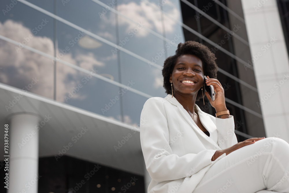 Wall mural portrait of elegant successful african woman with mobile phone	
