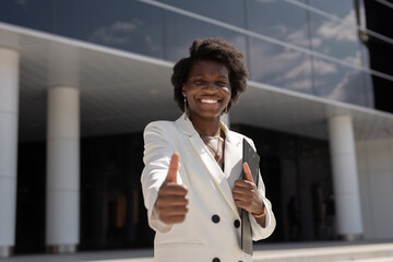 stylish african female in white suit with hand gesture