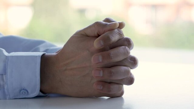 Close up of hands of nervous, anxious and worried man fidget with finger feeling stress, uncertain and overwhelmed while waiting for job interview. Fingers of worker with adhd feeling unsure, scared.