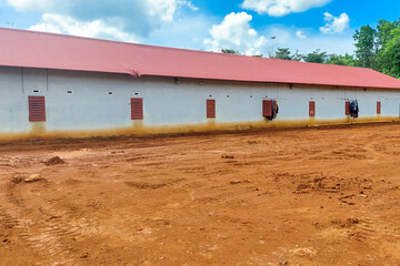 Fototapeta na wymiar red empty land in front of a white school building