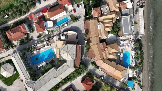 Aerial view of the beach and swimming pool at luxury resort. Luxury hotel,swimming pool drone photo. Holiday Resort in Zakynthos, Greece.