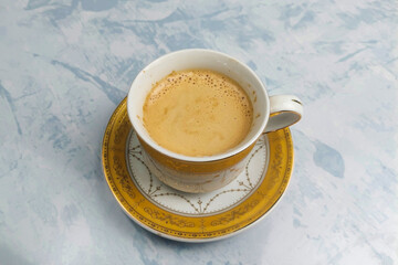 milk coffee in a white glass on a white table ready to drink