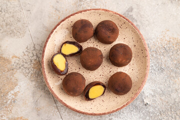 Japanese rice chocolate mochi filled with cream on brown concrete. top view, flat lay