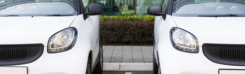 White rental cars in a row.