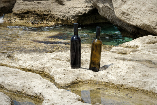 Two bottles of wine on the shore.