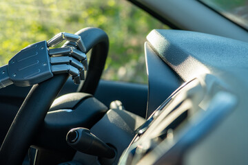 Robot arm on a steering wheel. Artificial intelligence drives a car. Autonomous vehicle concept
