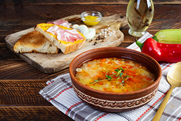 Minestrone soup. Vegetable soup with grilled bread, ham and spices