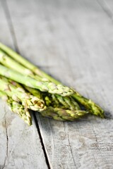  Green asparagus close up on wood white table.