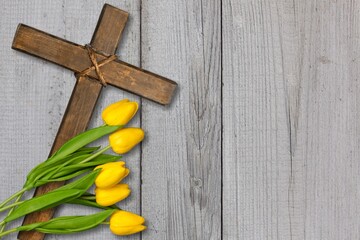 Easter wooden cross with fresh flowers