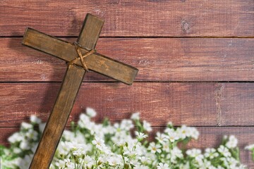 Easter wooden cross with fresh flowers