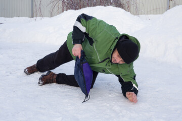 A European man slipped on the ice and fell.