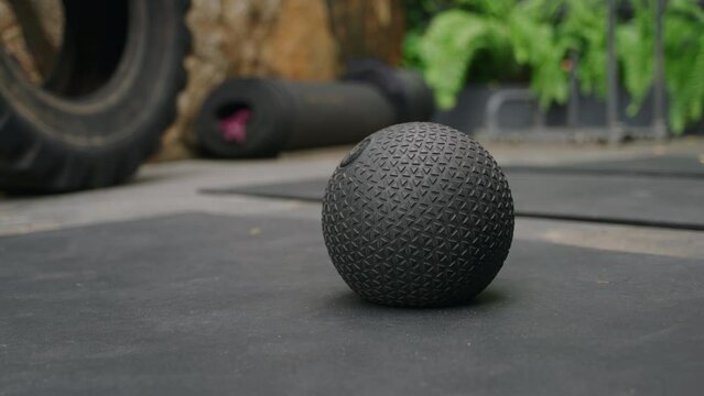 Slamball bounces on rubber floor at outdoor gym, players pass, jump, dunk in intense game. Match in progress with dynamic moves, teamwork in fitness training. Urban sports scene, active lifestyle.