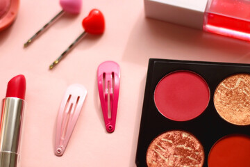 Various pink accessories and make up products on bright pink background. Selective focus.