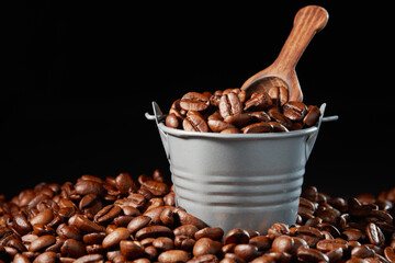 Roasted coffee beans in a bucket. Low angle view.