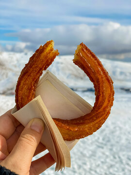 Halka Tatlisi in hand background snow. Turkish Churros
