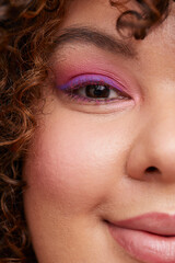 Brunette woman with pink eye shadows 