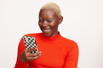 Smiling woman with short white hair, using smart phone