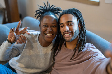 Portrait of happy couple sitting on sofa 