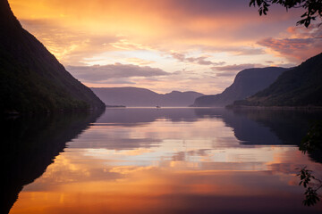 Boat in a fjord in Norway at sunset 
