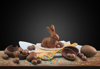 Delicious chocolate easter eggs and bunny on the desk