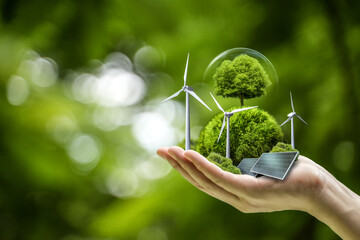 Business hand holds green globe with tree, wind turbine and solar powered for ESG, CO2 and Net Zero...