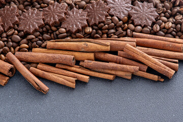 Food background. Coffee beans, cinnamon sticks, anise stars and chocolate candies top view.