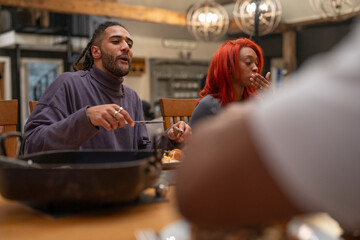Friends eating dinner together