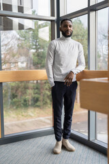 Portrait of young businessman standing in office