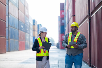 Warehouse engineer inspects merchandise with large customer at industrial container yard.