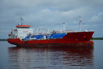 Ecological risks from cargo ships in the sensitive biodiversity of Amazonia. Red gas tanker from...