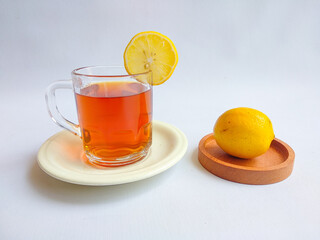 A cup of hot lemon tea on white background