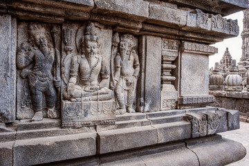 Fototapeta na wymiar Stone carvings on the ancient walls of Prambanan temple in Indonesia