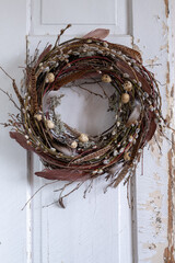 Easter wreath made of natural materials - a branch of moss feathers and quail eggs. Spring decor...