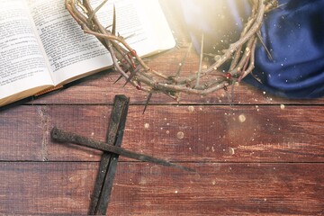 Crown of thorns on holy Bible with flower. Easter concept.
