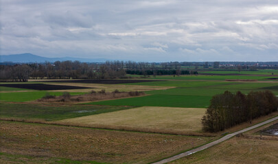 Fields and meadows on a cloudy winter day with a view of the Bergstrasse