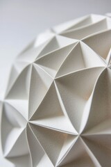 Origami sphere made of white paper close up